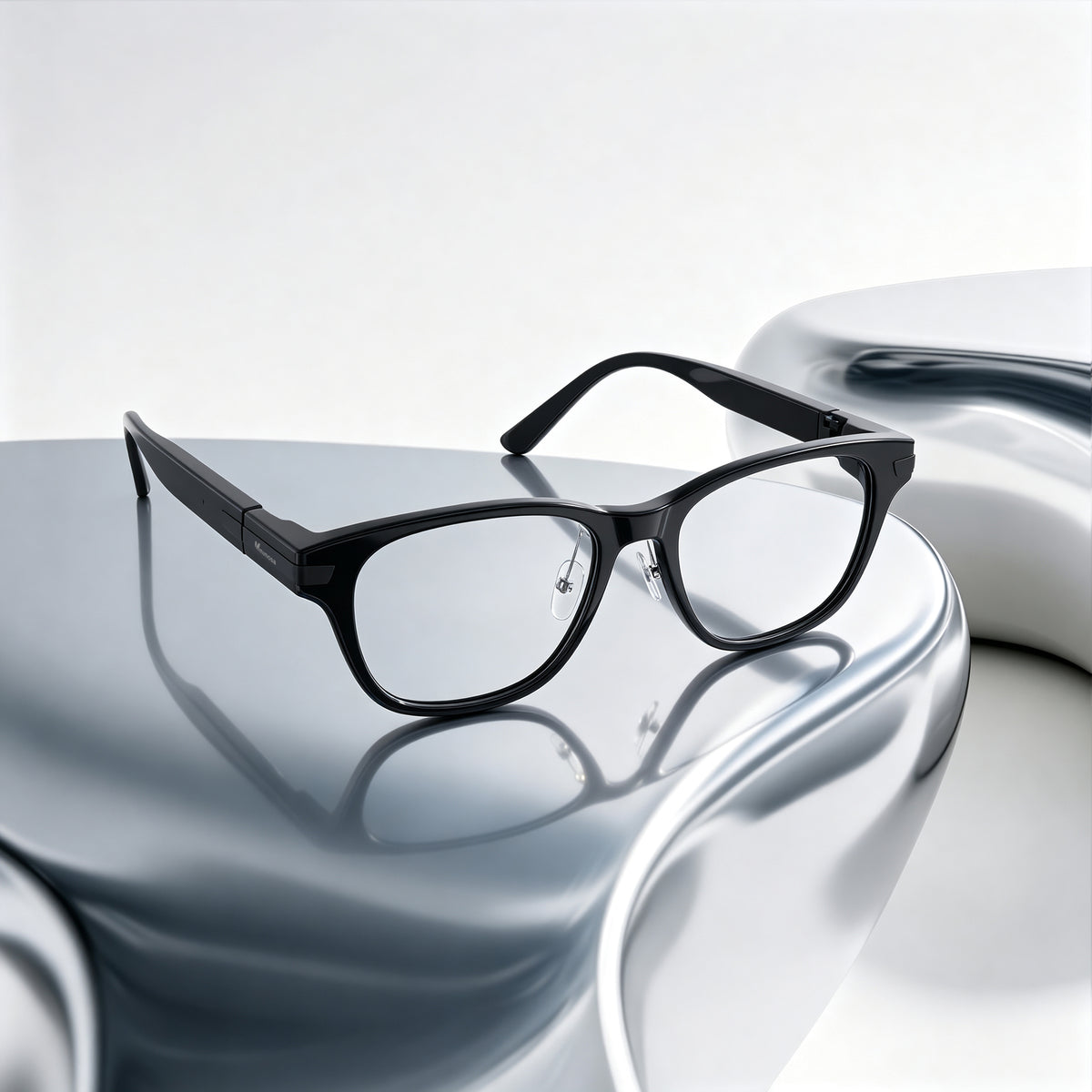 Hearview Lite black Classic subtitle glasses on a polished silver surface